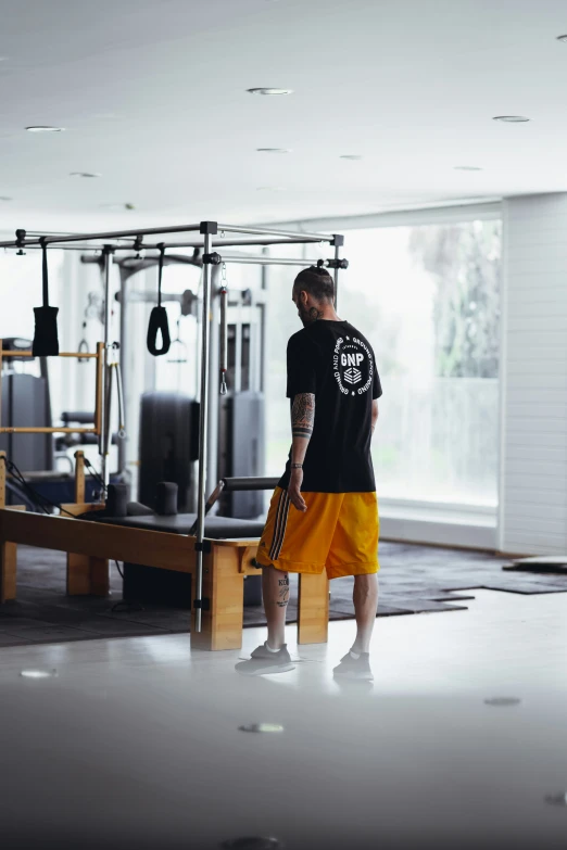 a man is holding a gym rope while looking in to the gym