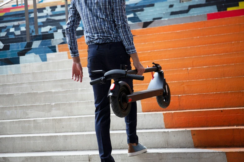 a man on a bicycle is going up a flight of steps