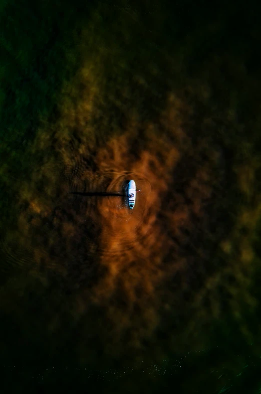 a boat on water surrounded by an orange and green background