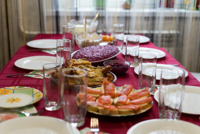 a table is set for a meal with wine glasses