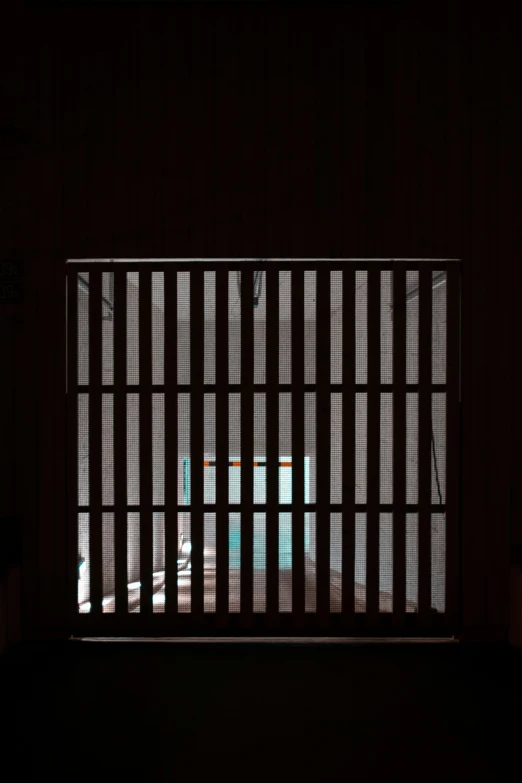 a  cell with a toilet and window in the dark