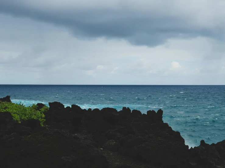 the view of a body of water with rocky cliffs