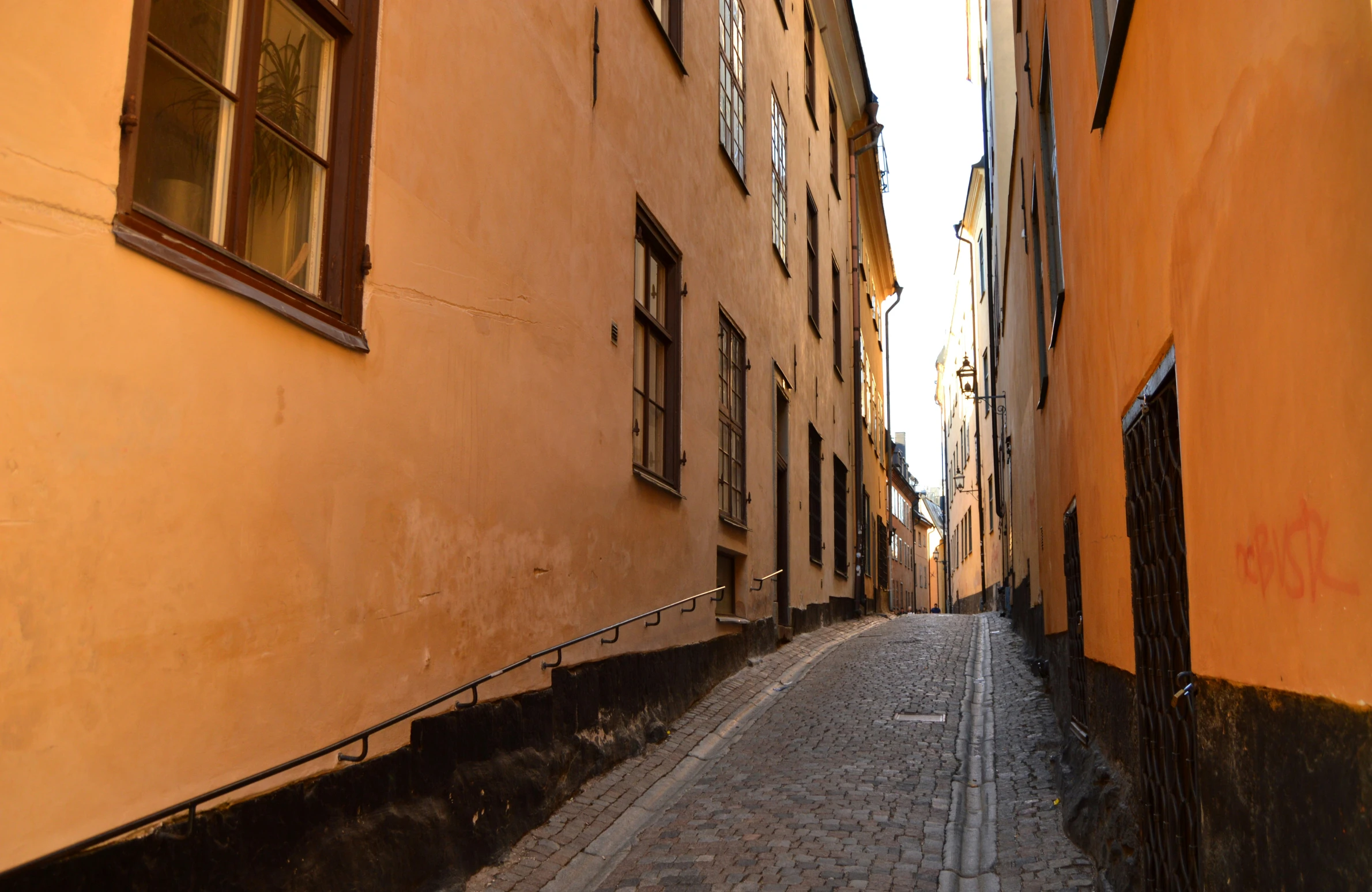 a narrow street is seen on an otherwise empty day