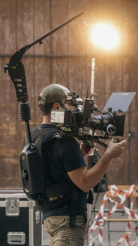 a man that is standing up with a video camera