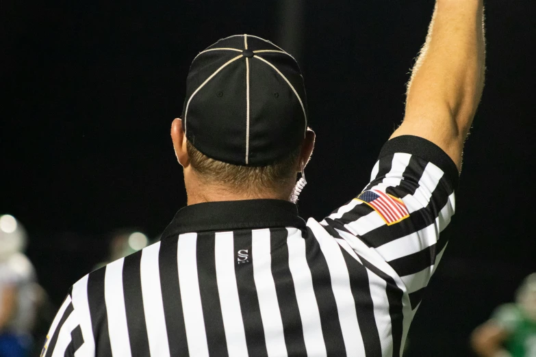 a referee waves at the referees while he stands in line