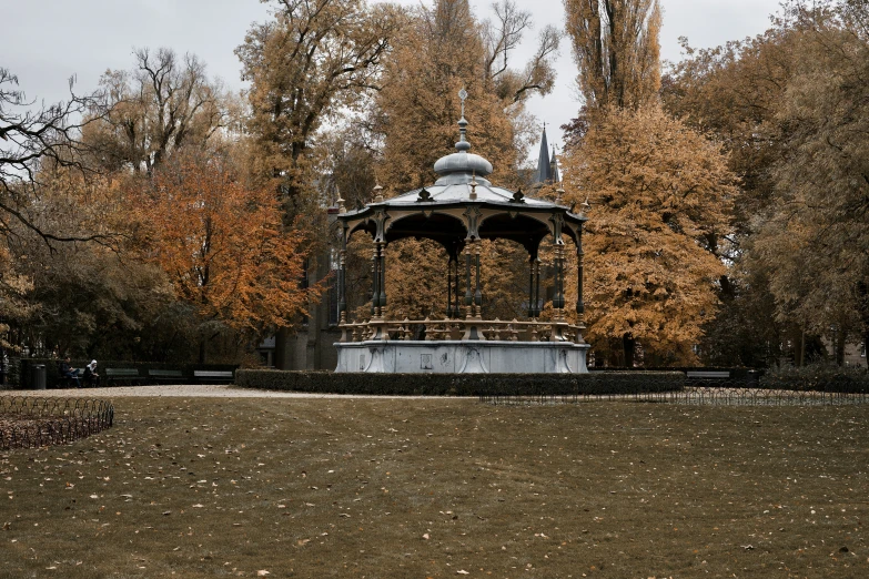 there is a white gazebo with a clock on it