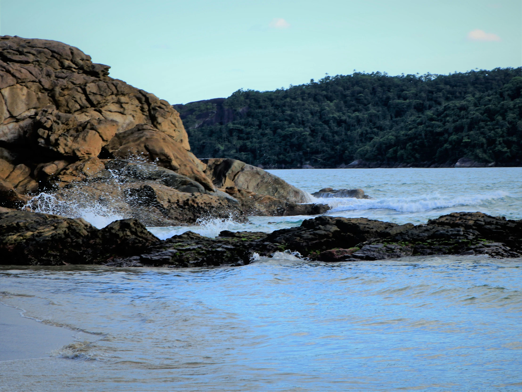 a surfboarder is riding on the waves of the ocean