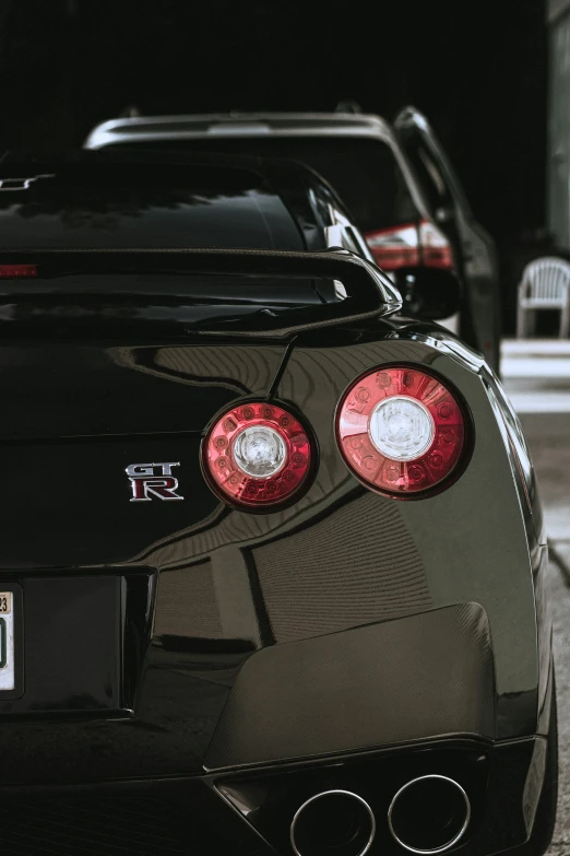 a black sports car parked on the sidewalk