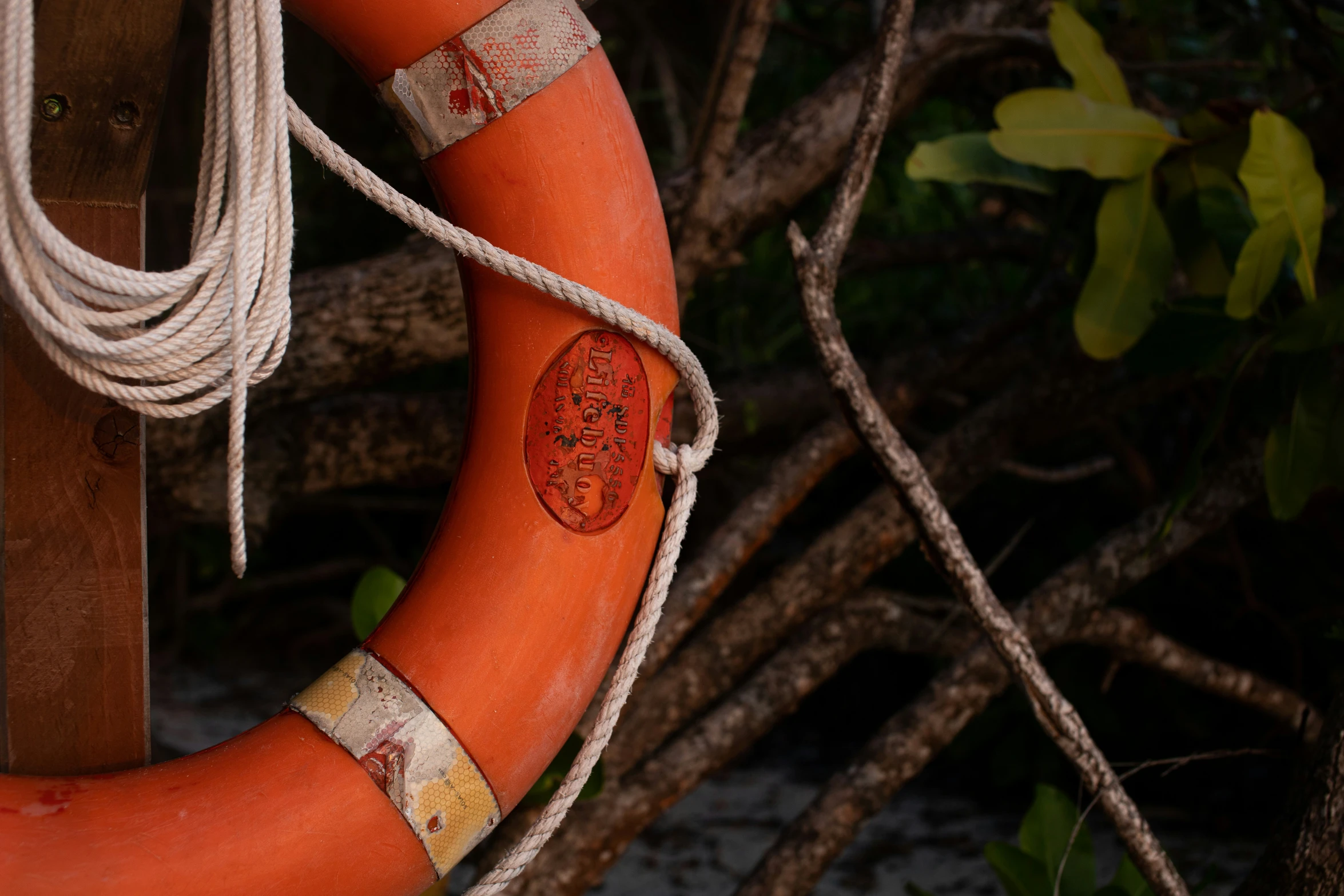 a life preserver hangs on a wooden post