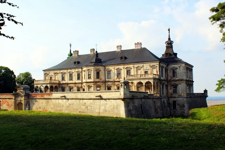 a large building sitting next to a lush green field