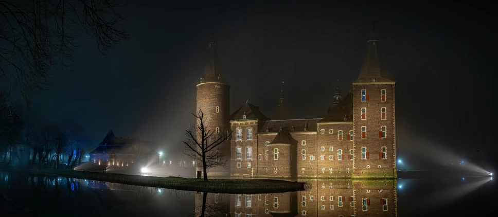 buildings reflected in the water at night time