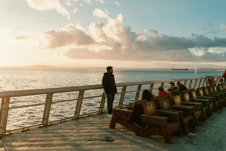 a person looking over a wooden railing on a body of water