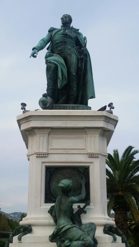 a statue on top of a white pedestal