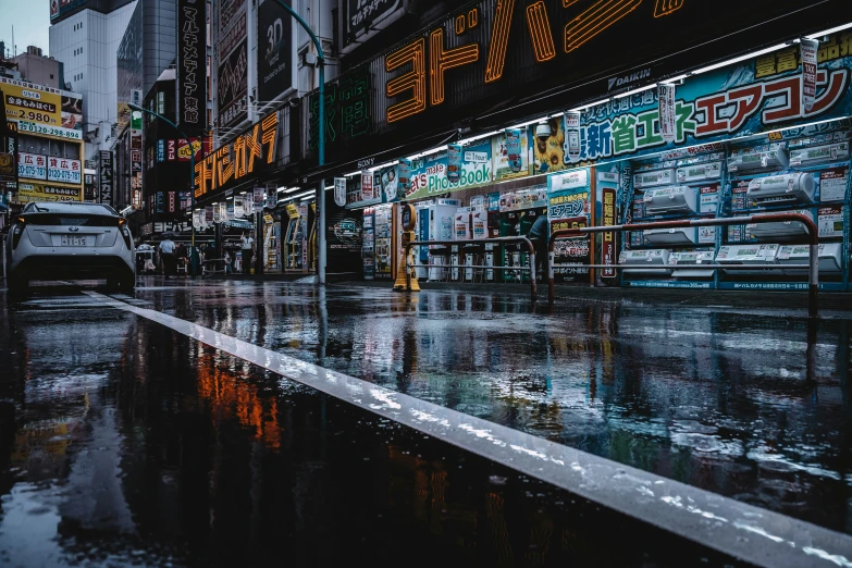 a wet sidewalk with buildings reflecting in it