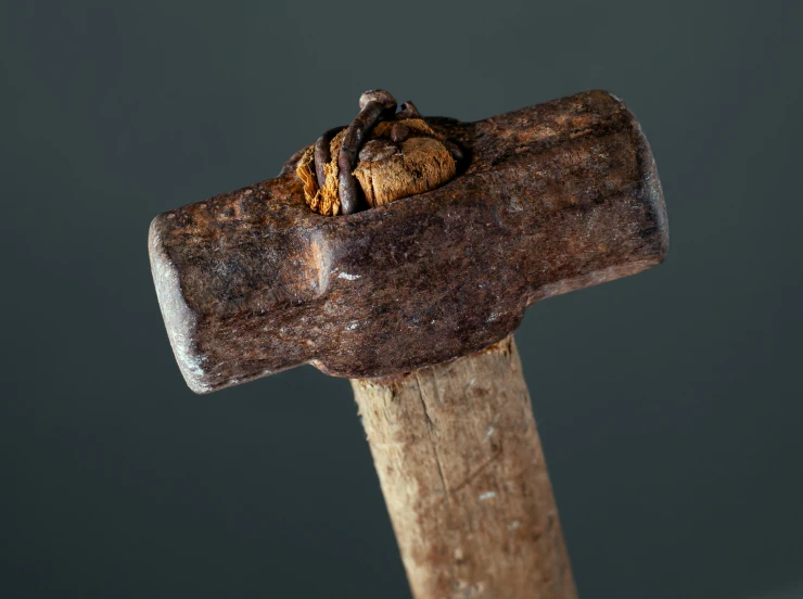 an upturned axe is on the wood with brown bits in it