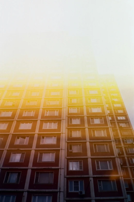 an image of a building with windows and a clock in the middle