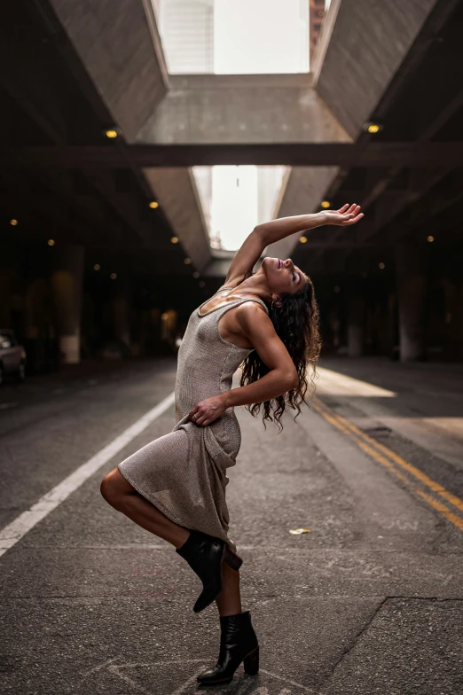 a woman in a silver dress is dancing