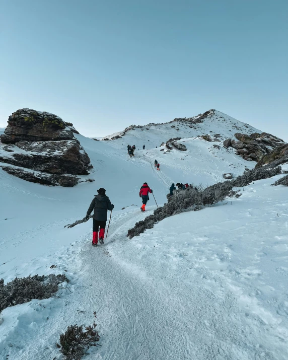 skiers are skiing across a very snowy mountain