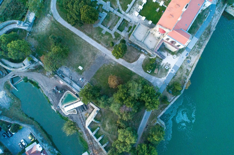 an aerial view of a river running next to houses