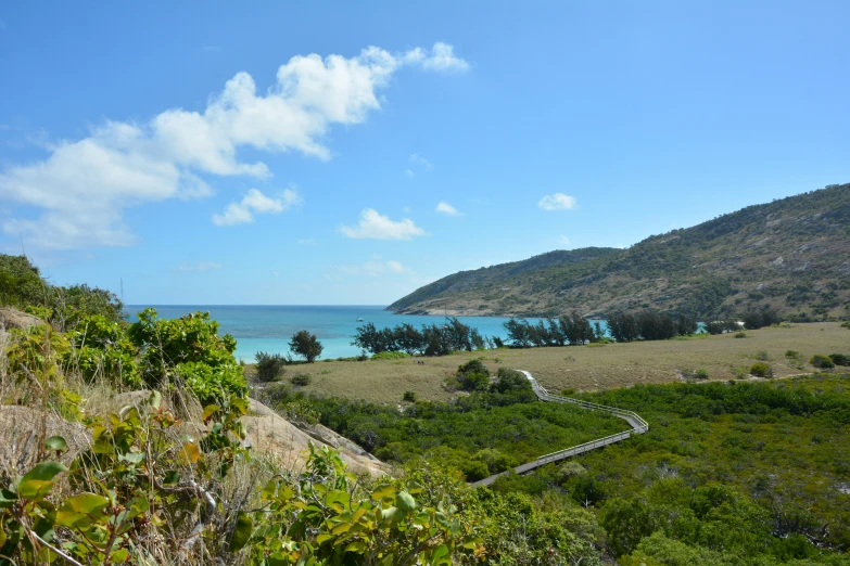 an image of the ocean water and hills