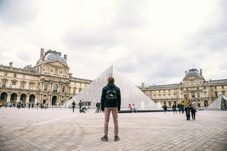 person standing in front of the pyramid building