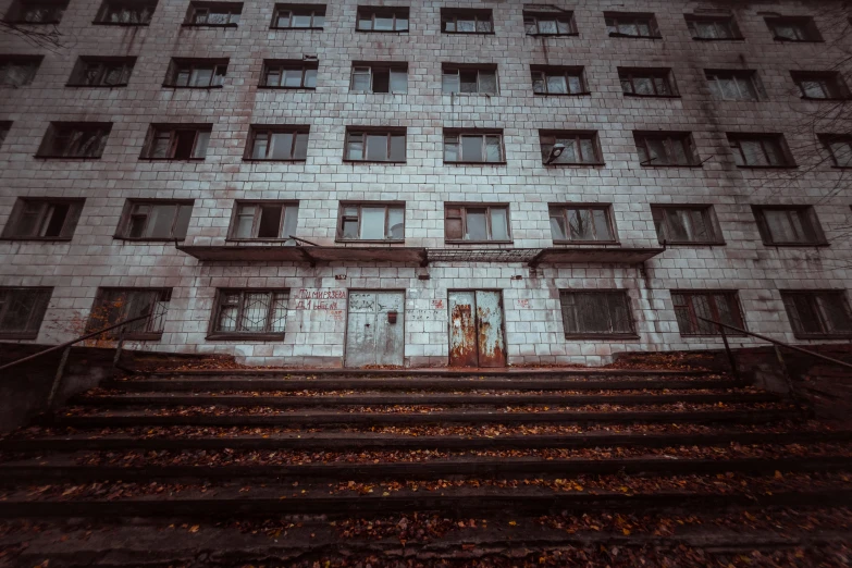 an old building with large windows and some staircases in front