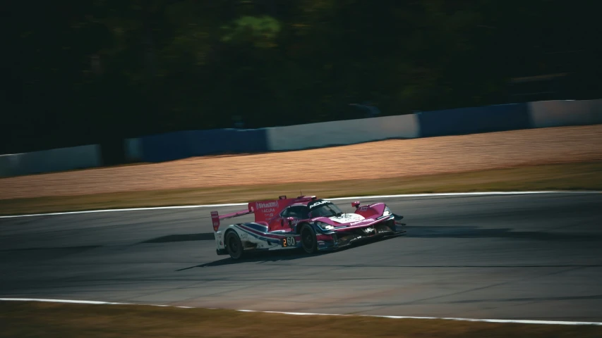 a race car driving on a race track at night