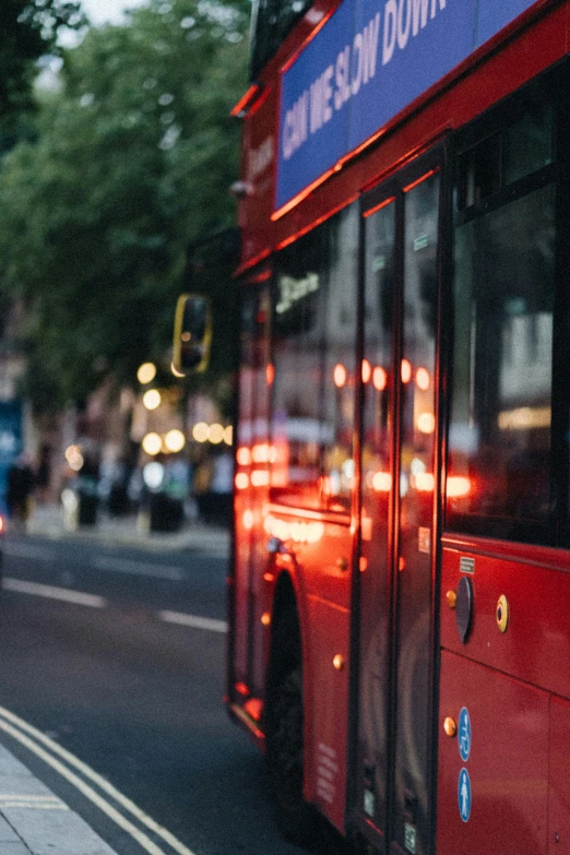 a red double decker bus parked on the side of the road