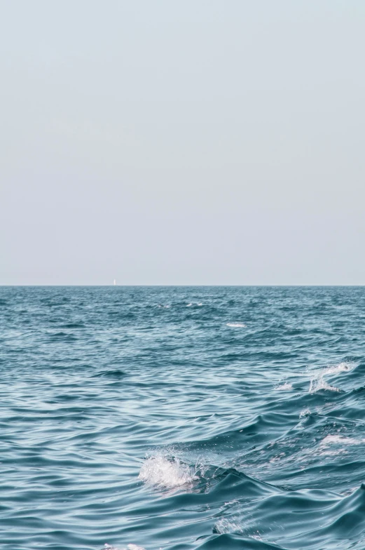 a person is standing on surfboards in the middle of the ocean