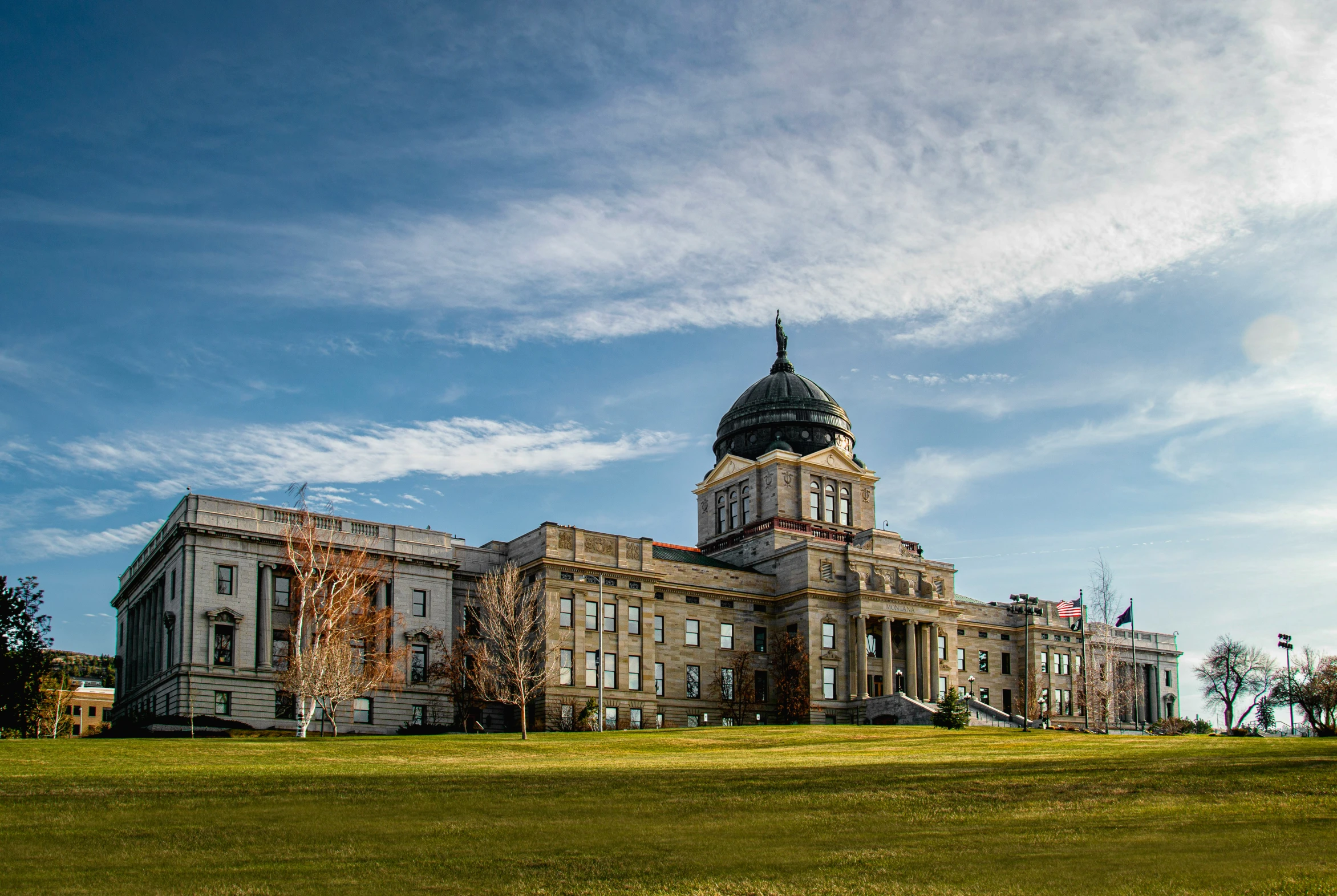 the building has several turrets and many flags on it