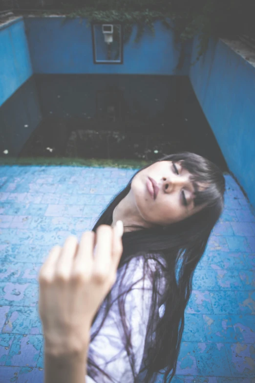 a woman is posing in the middle of an alley