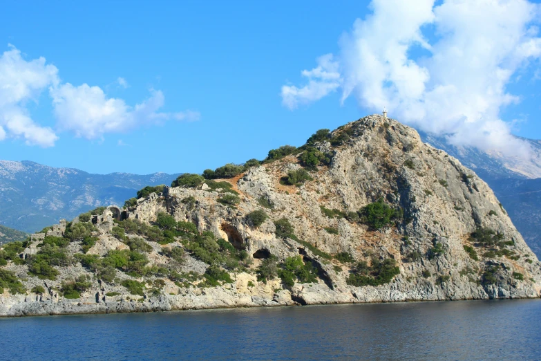 there is a large rock that looks like it was built on the top of an island