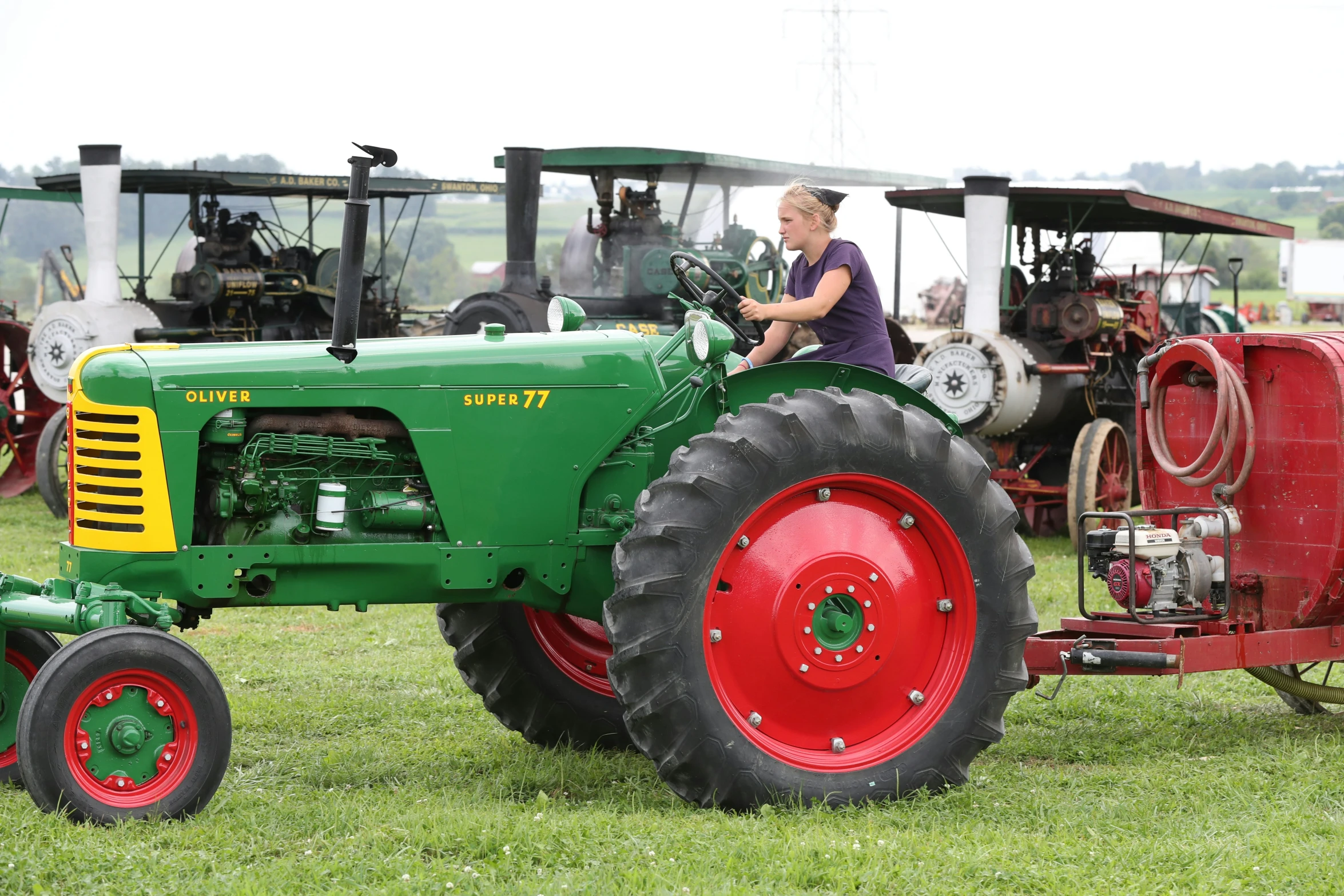 the two men are driving tractor in the field