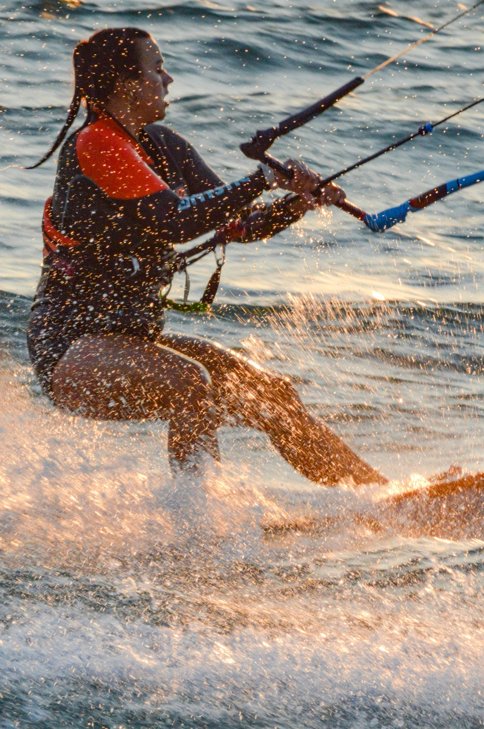 person on surf board and holding hands with poles in water