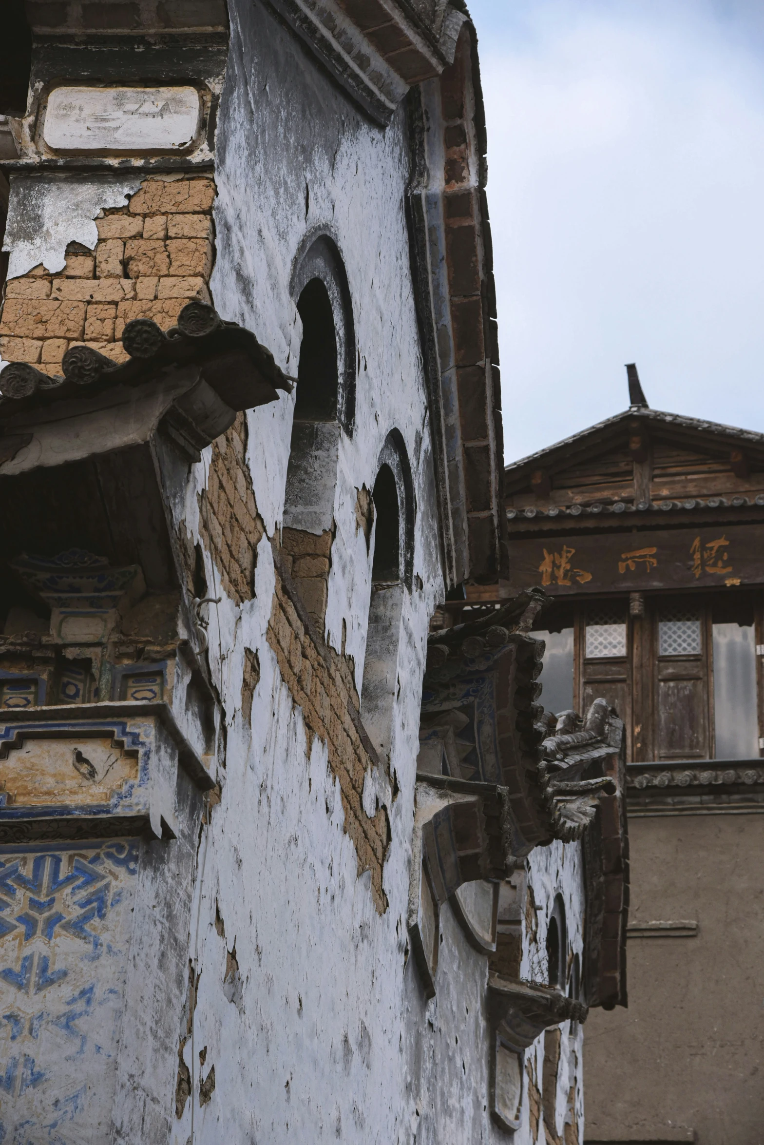 old building with missing roof and windows with rusted roof