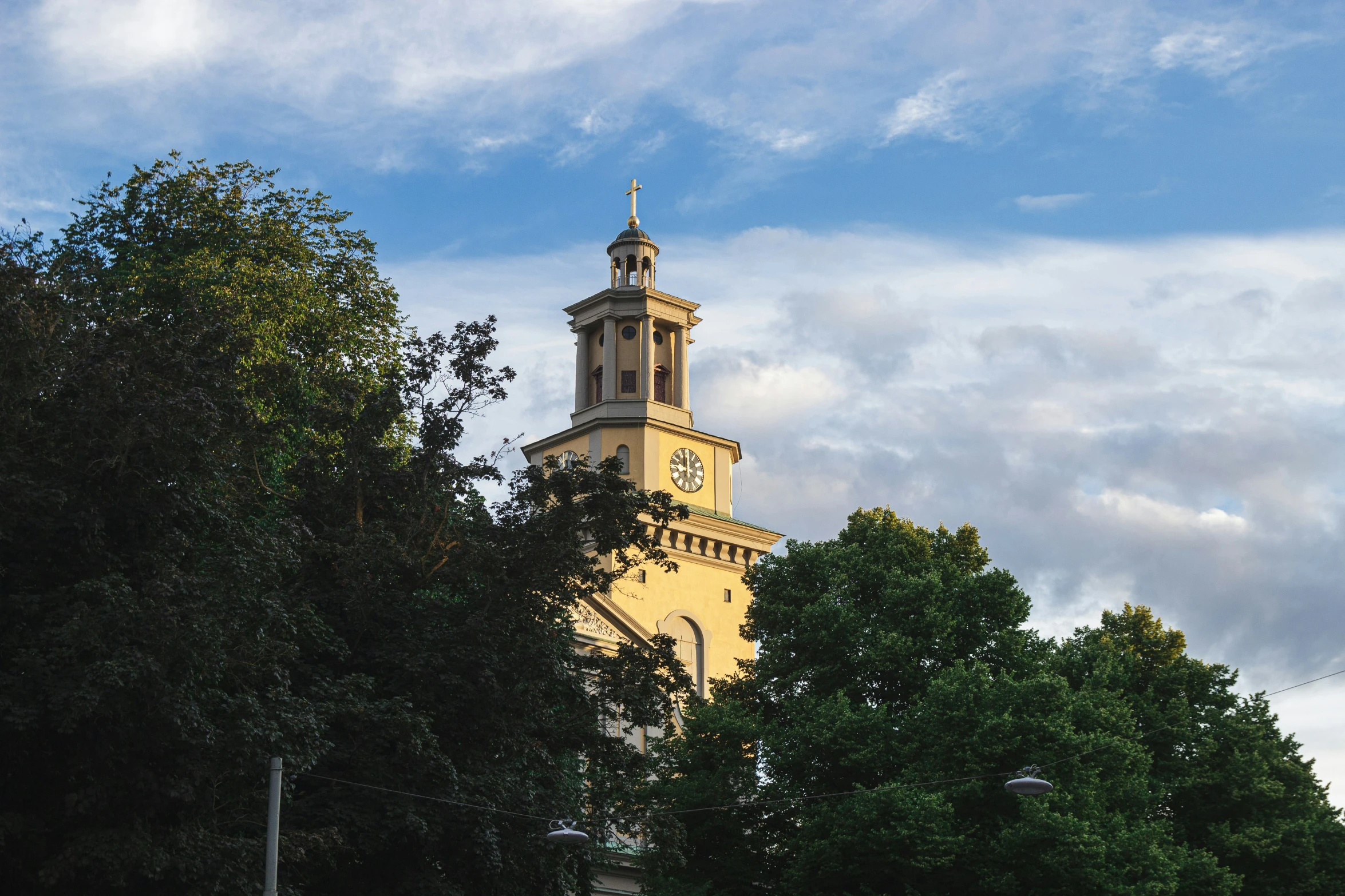 a clock tower with some trees around it