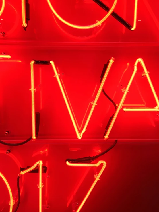 a close up of neon signs on a wall