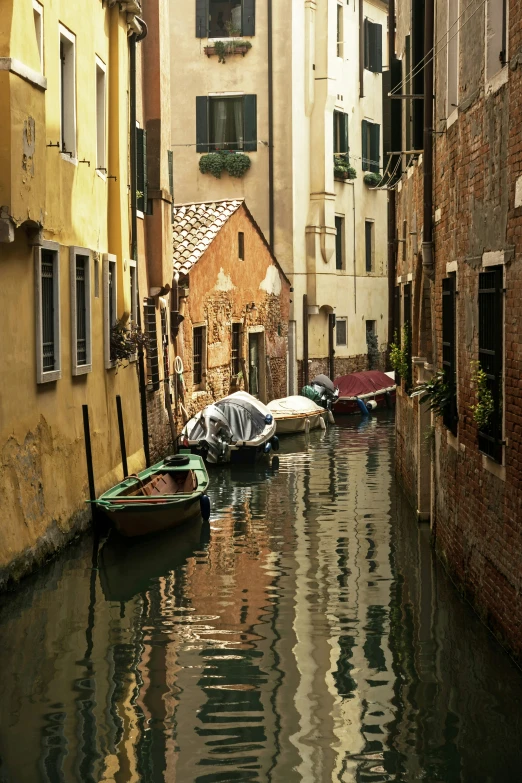 boats in the water among buildings with balconies