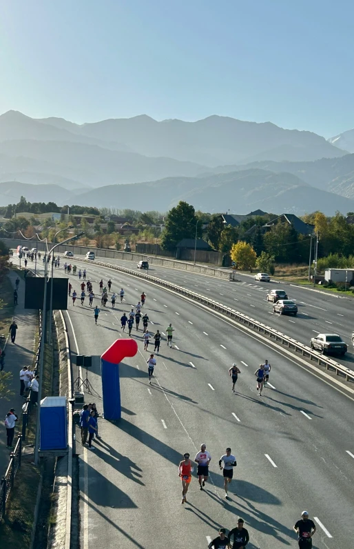 many people run on the road next to some traffic