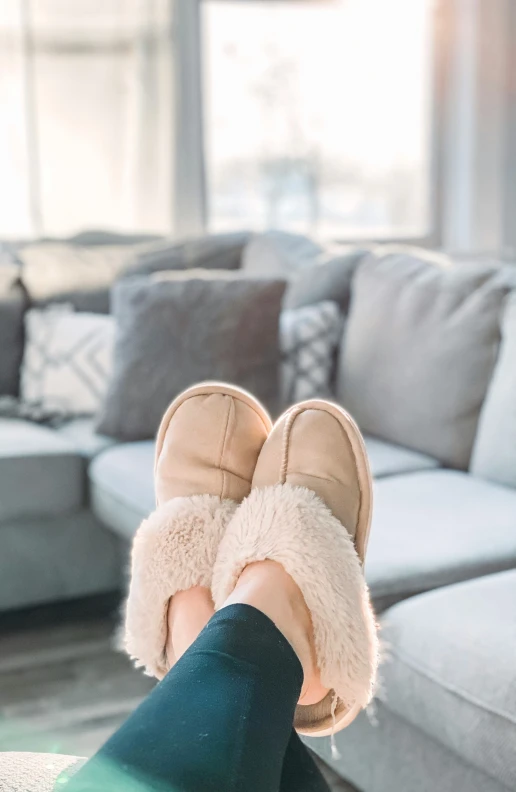 someone wearing slippers and standing in a room