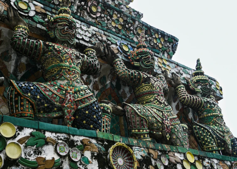 the intricately designed and painted sculptures on top of a building