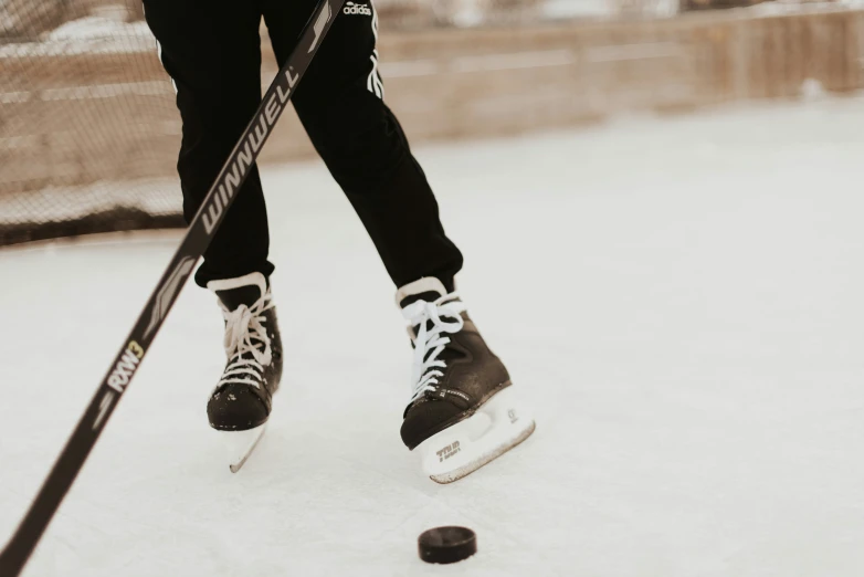 the legs and shoes of an ice skater in black and white