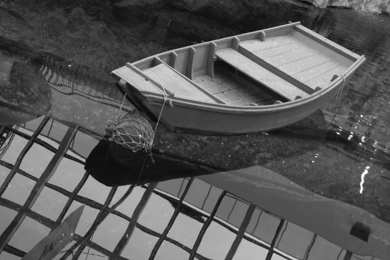 a row boat sitting on top of a body of water