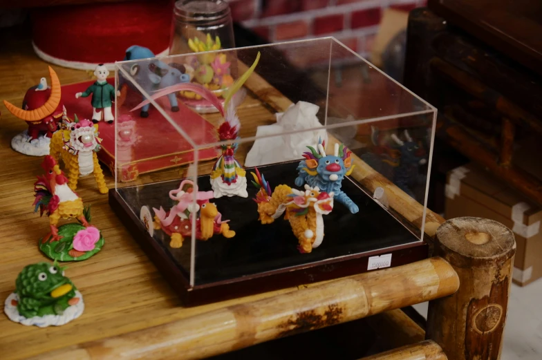 some small colorful toy figurines in a case