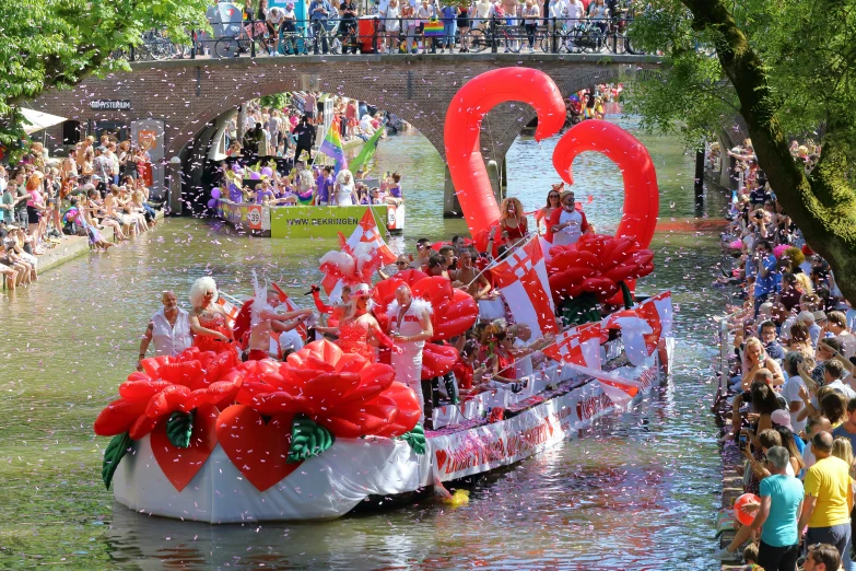 boat with many people and numbers on it riding in water