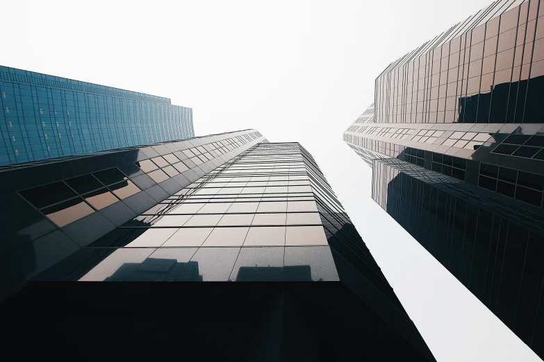 looking up at two tall buildings from the ground