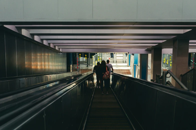 a view of some people walking across the train tracks