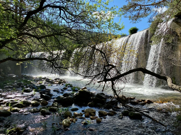 a river flowing down into a canyon underneath a large waterfall