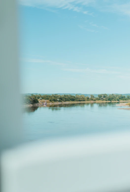 the view of a calm body of water through a window