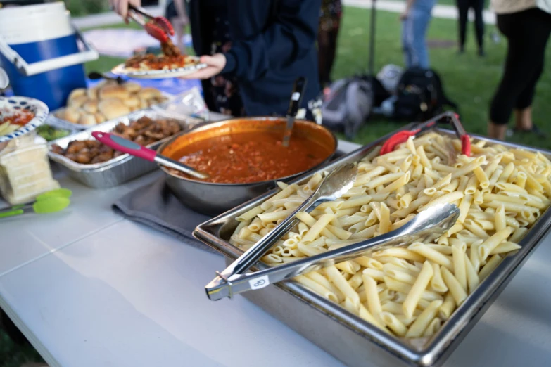 a table full of different types of pasta and meat